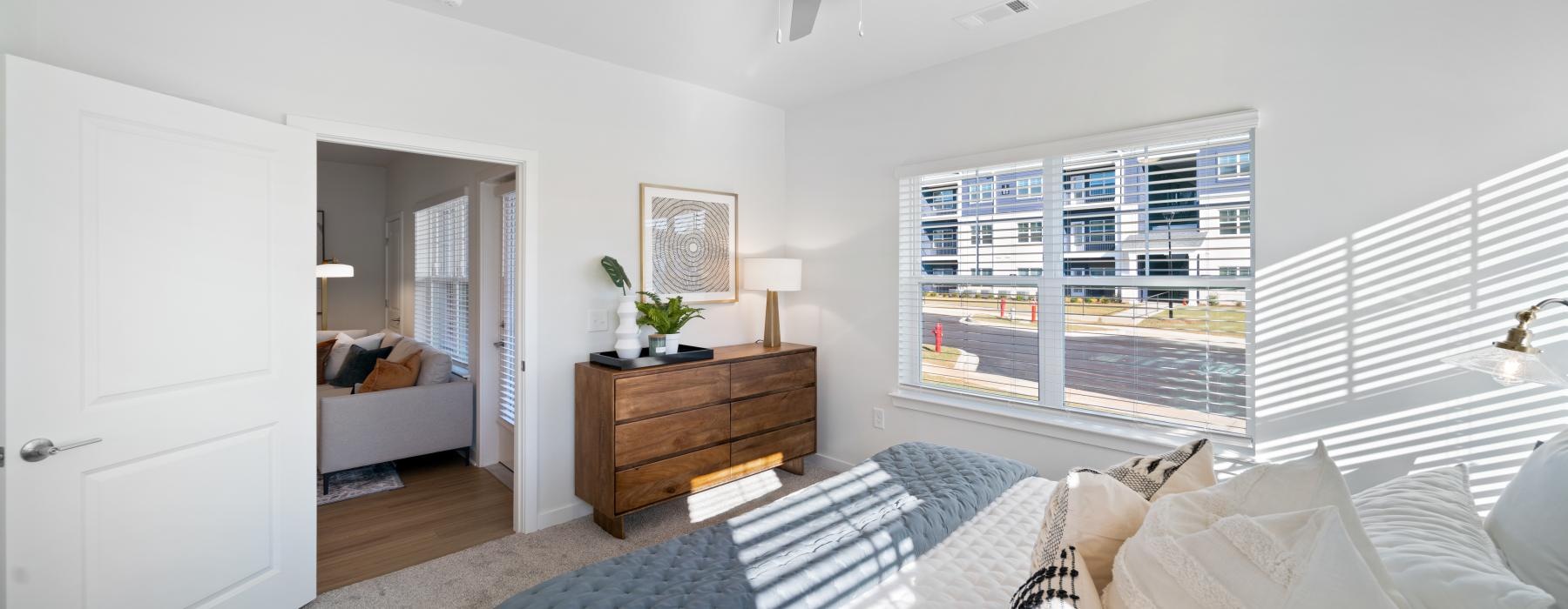 a bedroom with a bed and a fan