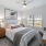 a bedroom with a bed desk and a window
