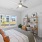 a bedroom with a bed and a shelf with a lamp