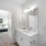 a bathroom with a sink and a bed