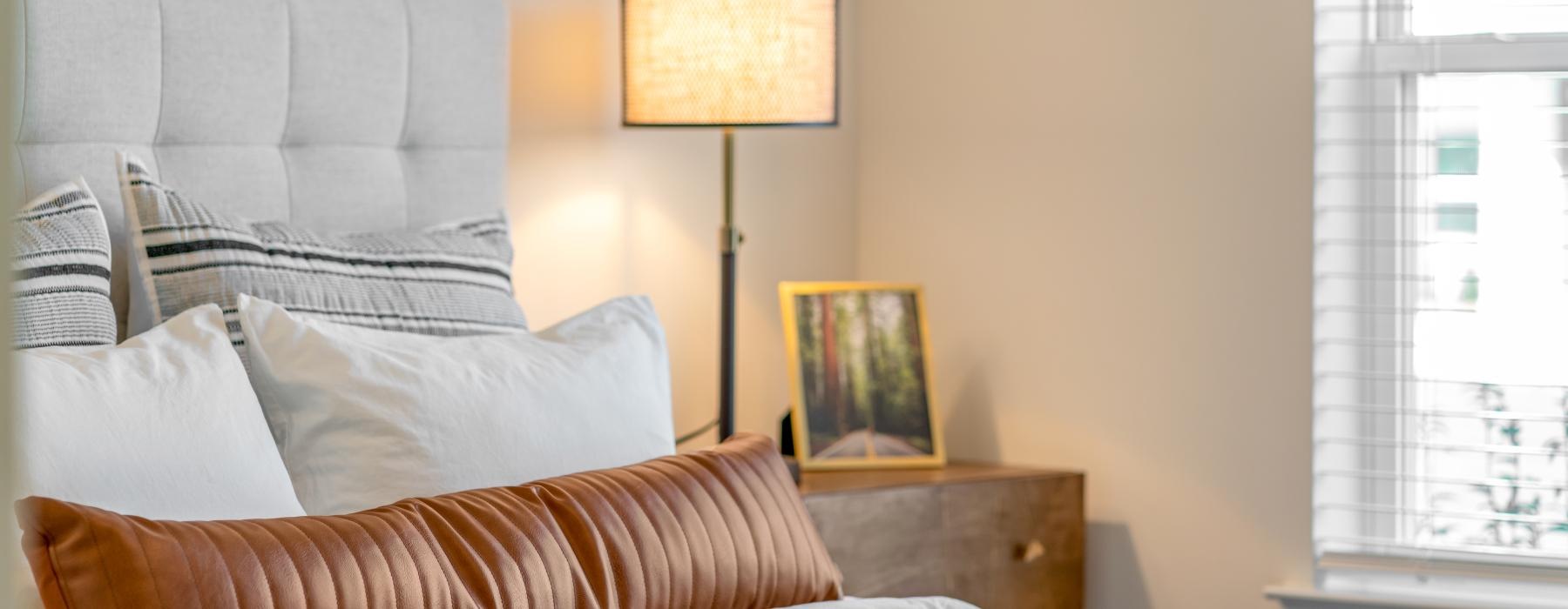 a bed with a lamp on the side